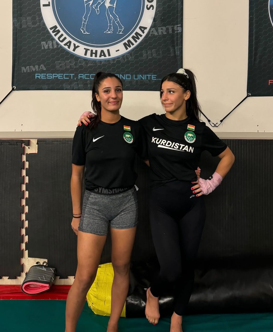 Two Kurdish fighters in Kurdistan training shirts in their Muay Thai gym