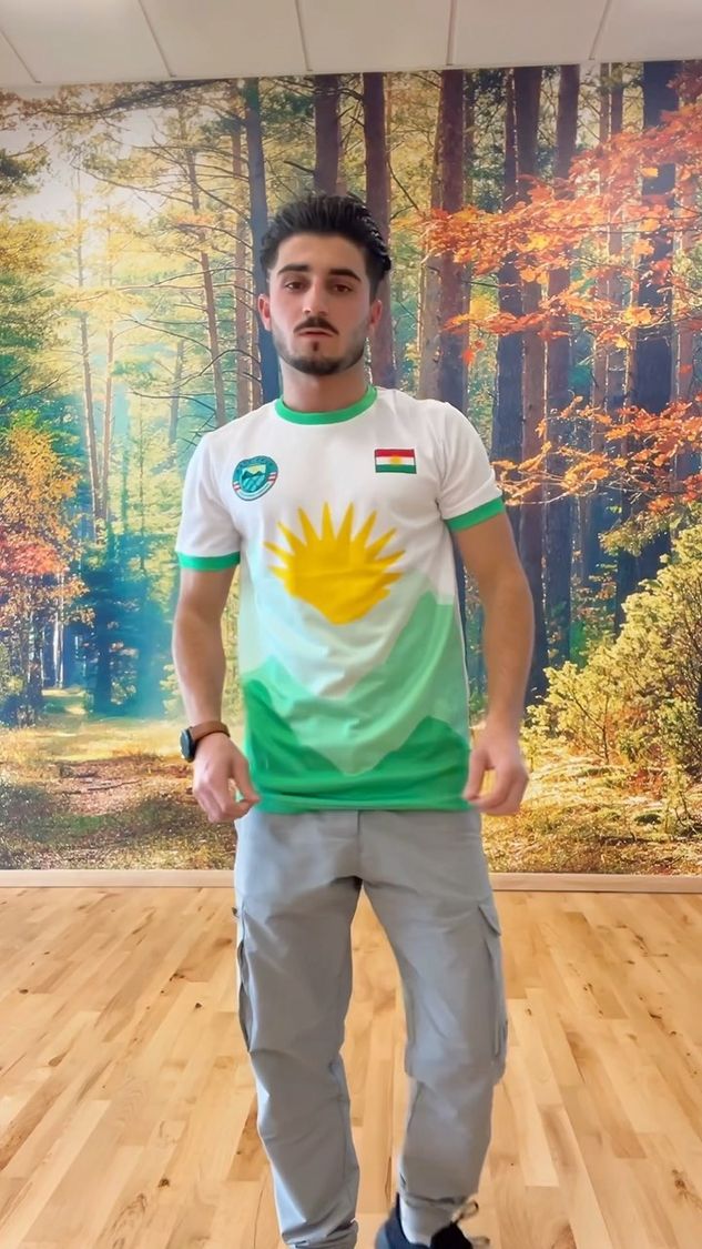 Young Kurdish man with the flag of Kurdistan as a scarf