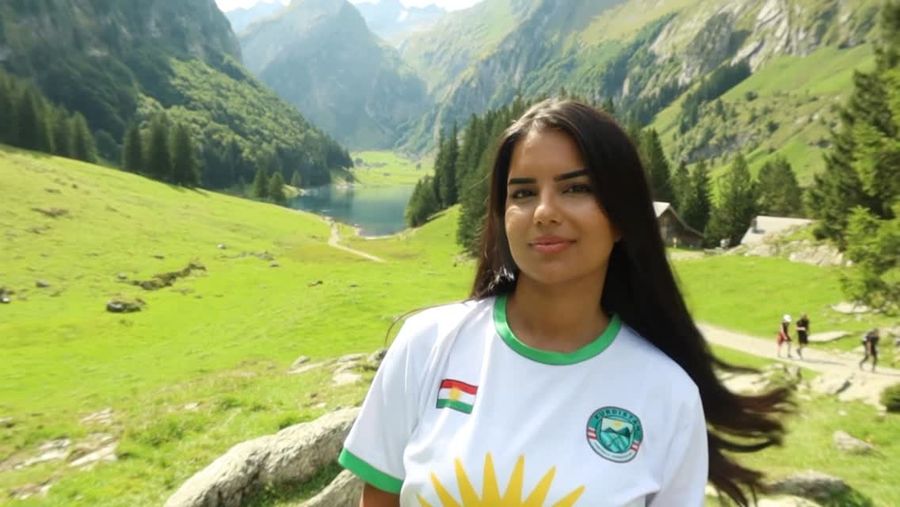 Kurdish woman in a Kurdistan shirt in the mountains