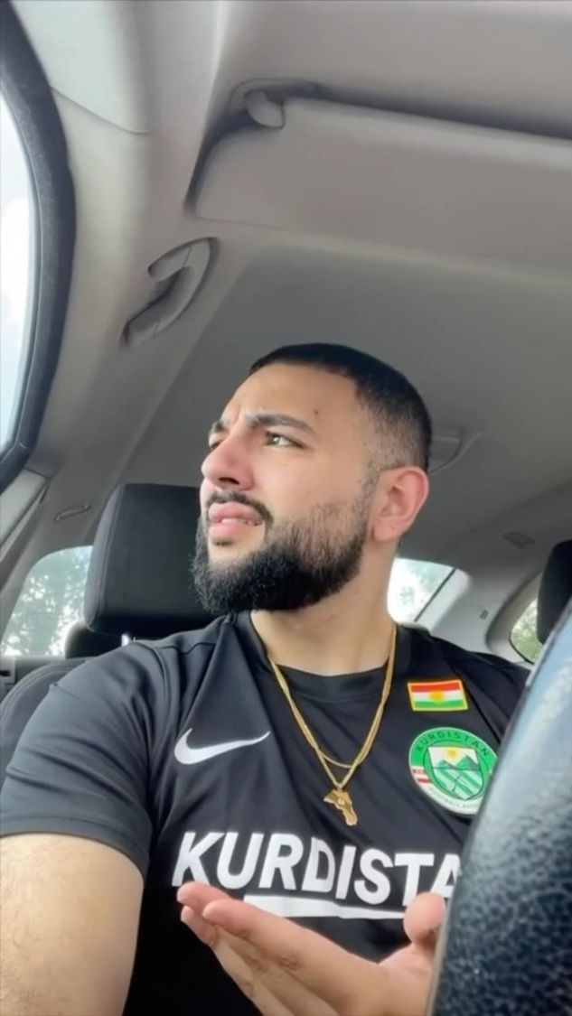 Kurdish man smiling in a Kurdistan training jacket