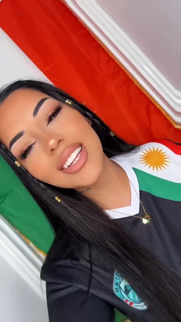 Two smiling Kurdish women in Kurdistan shirts