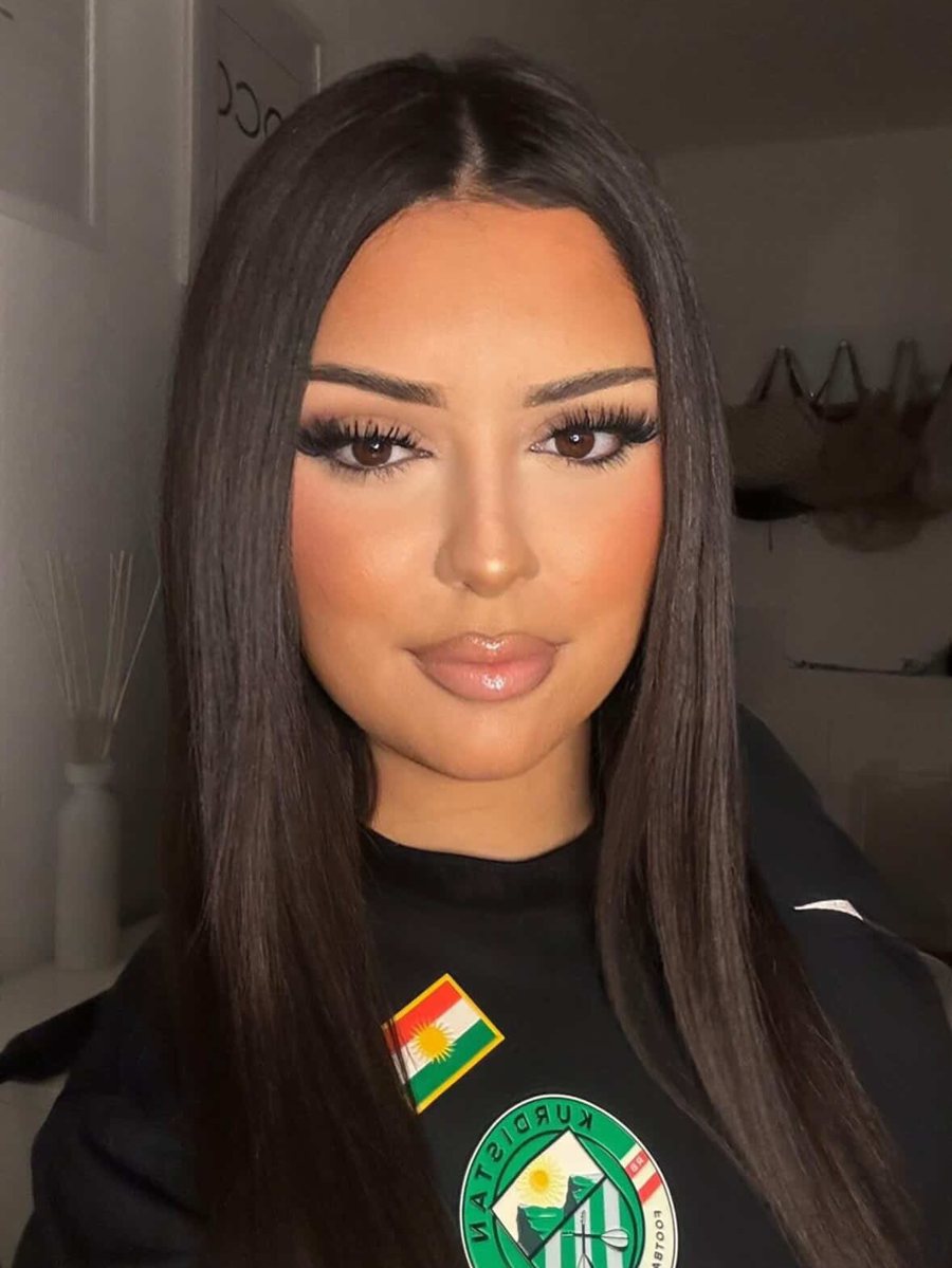 Portrait of a young Kurdish woman in a Kurdistan Nike shirt with the crest and the flag